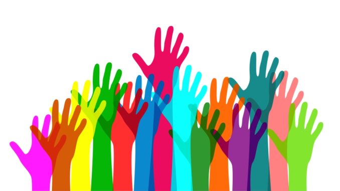 Colorful hands raised in happiness